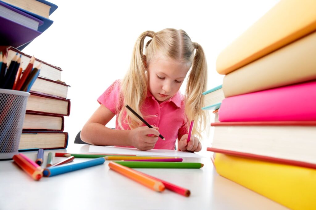 Concentrated girl surrounded by colorful books